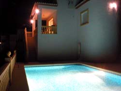 Pool and veranda at night, villa, Denia, Spain